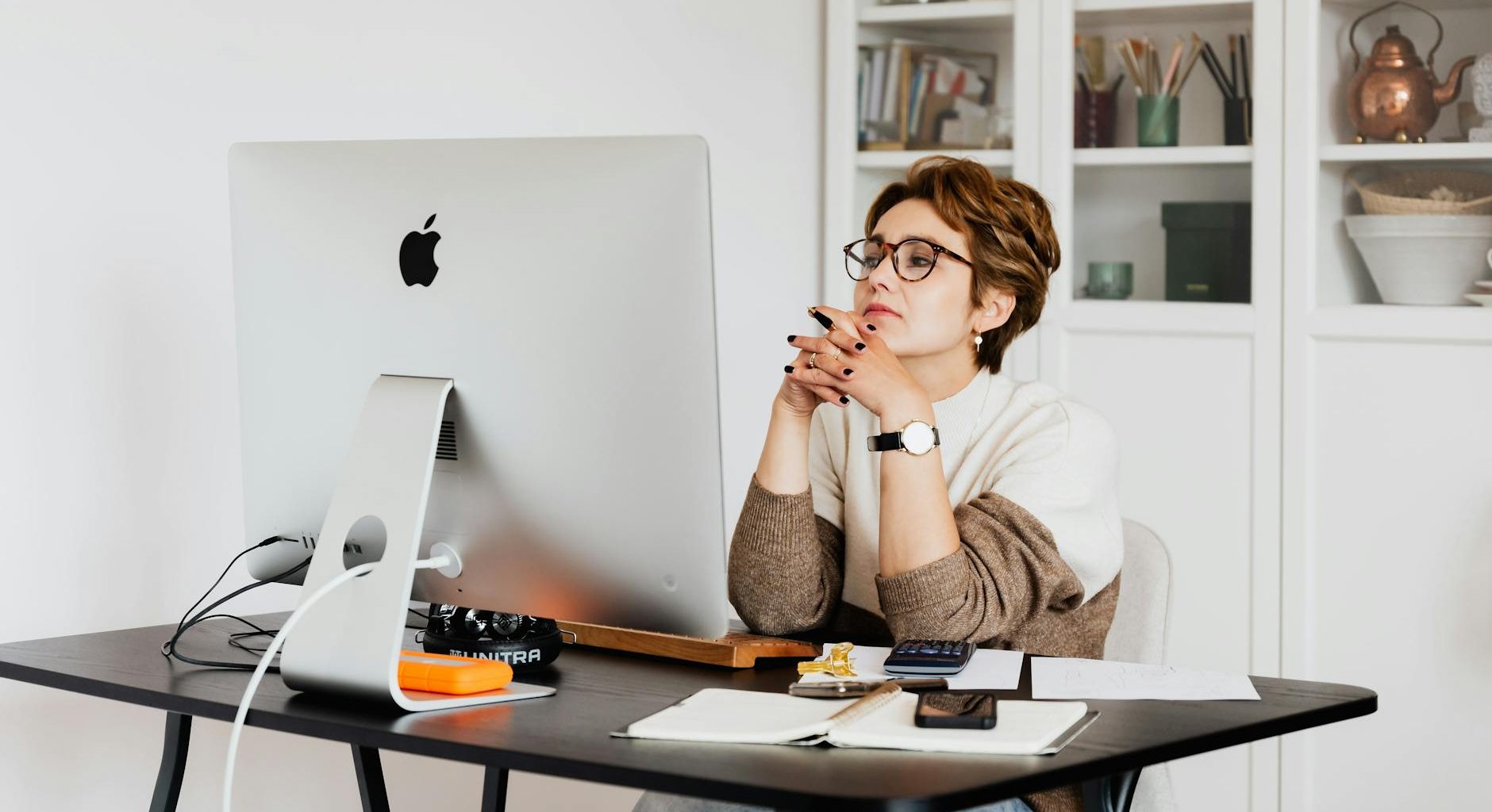 focused female employee reading information on computer in office
