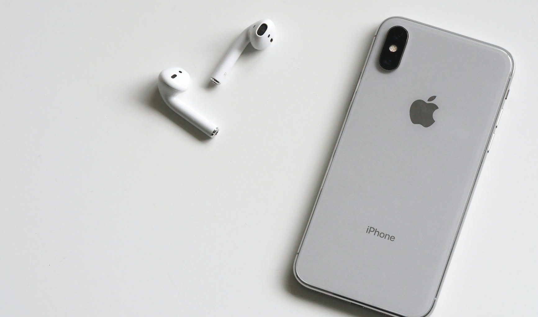 silver iphone x with airpods